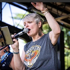Lead vocalist singing live on stage with arm raised