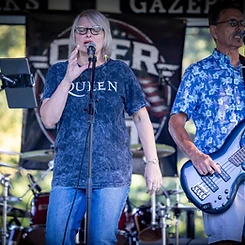 Lead vocalist singing with the bass player beside her