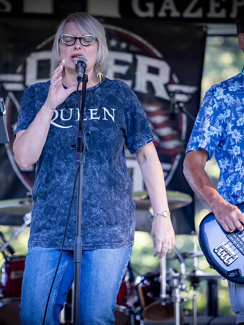 Lead vocalist singing with the bass player beside her