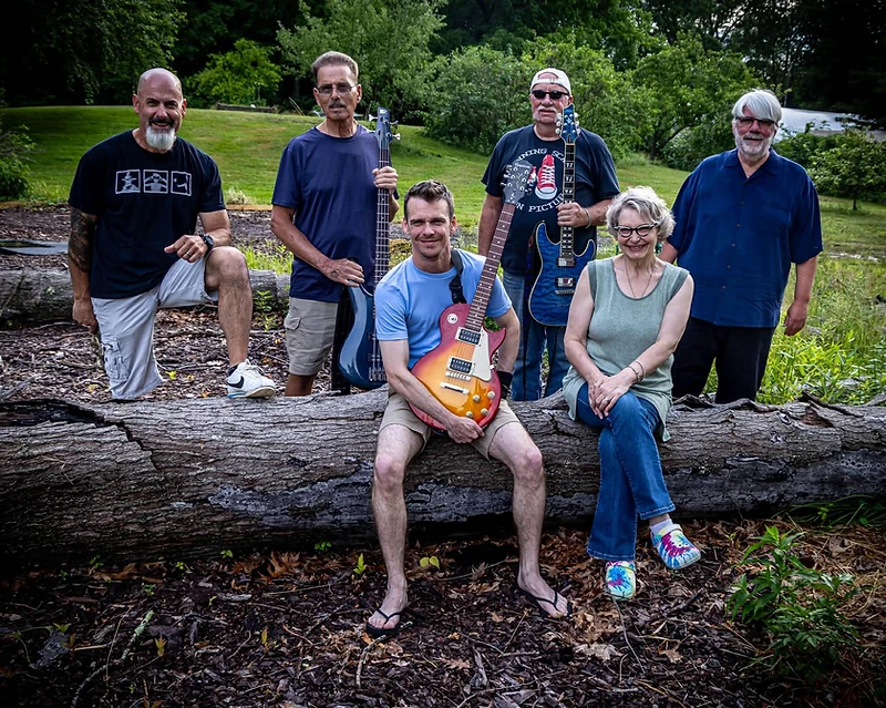 Over and Out band posing together outdoors