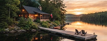 Lakefront cottage on a calm Ontario lake at sunset with a wooden dock and canoe