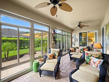 Sunroom interior with seating area and ceiling fans