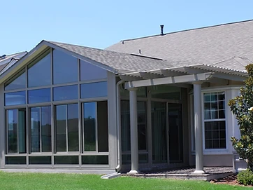 Cathedral sunroom combined with attached classic pergola