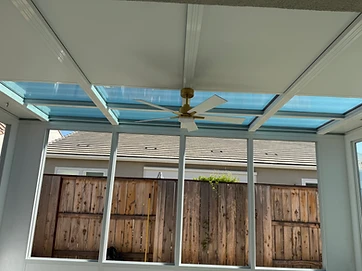 Modern sunroom interior with vaulted ceiling and garden views