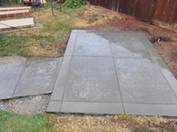 Newly poured concrete patio slab and walkway with score lines