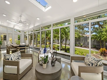 Luxury glass sunroom interior with louvered pergola attachment