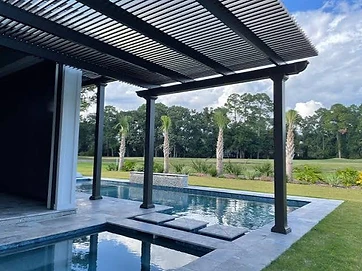 Modern dark louvered pergola over pool deck with stepping stones and palm trees