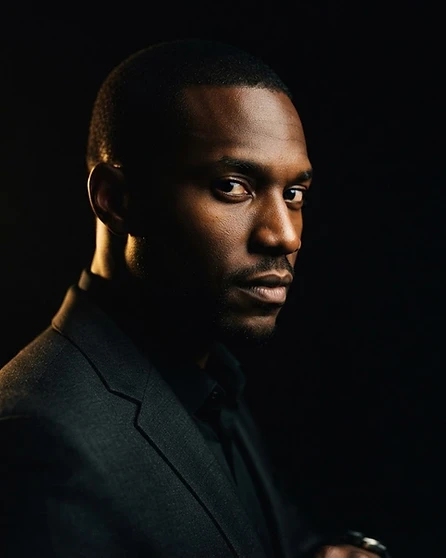 J, the elite covert operative at the centre of the Gentleman Zero espionage thriller, half-lit in shadow