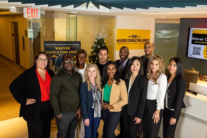 Waiver Consulting Group consultants smiling in the office lobby