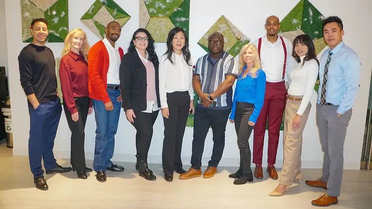 Waiver Consulting Group consultants standing together in the office