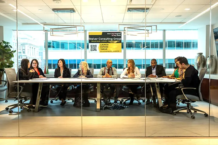 The Waiver Consulting Group team in a full boardroom review meeting overlooking Philadelphia