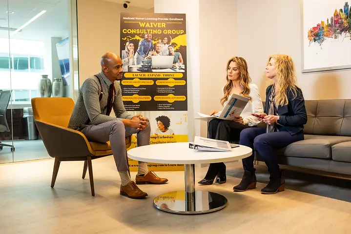 A consultant meeting two prospective providers in the office lounge