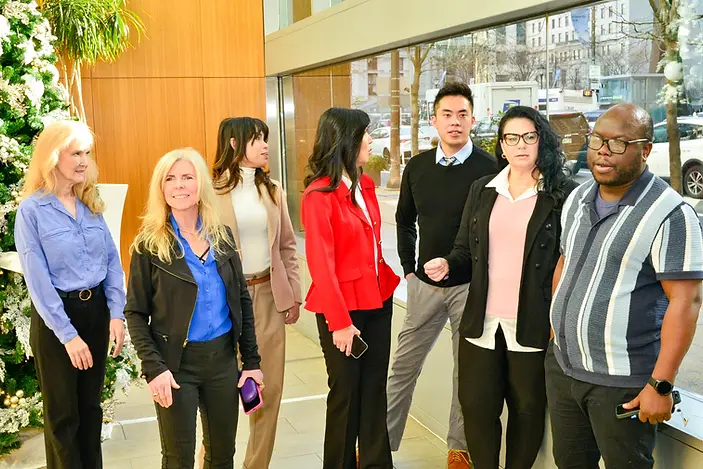 Team members talking in the office lobby