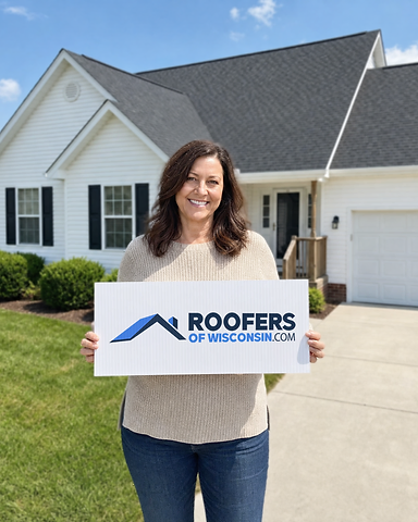 Cindy S., a happy Wisconsin homeowner holding a Roofers of Wisconsin sign