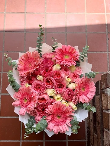 A hand-tied blush and sage bouquet by Bouquets by Kass