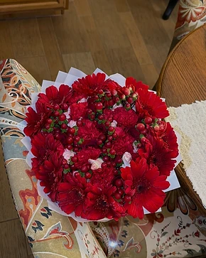 A bouquet resting on a vintage chair