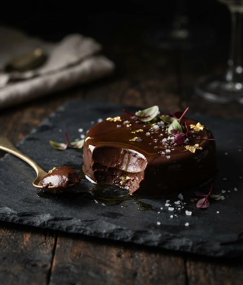 A plated dish in low candlelight