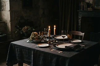 A private dining table set with linen and candlelight