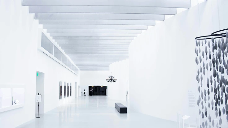 A minimalist museum gallery interior with vaulted ceiling