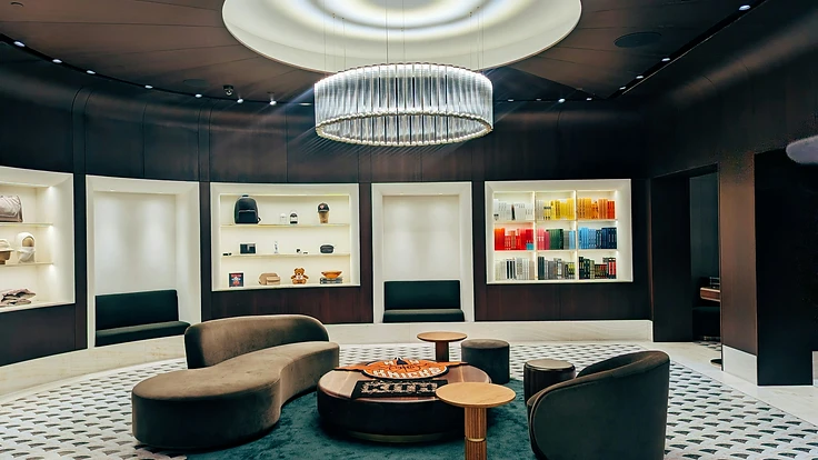 A luxurious library-inspired interior with illuminated display alcoves