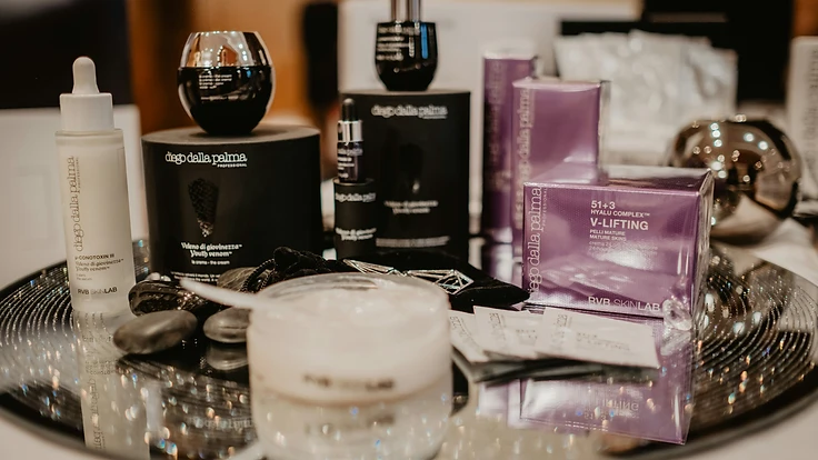 Prestige beauty product photography on a dark reflective display tray