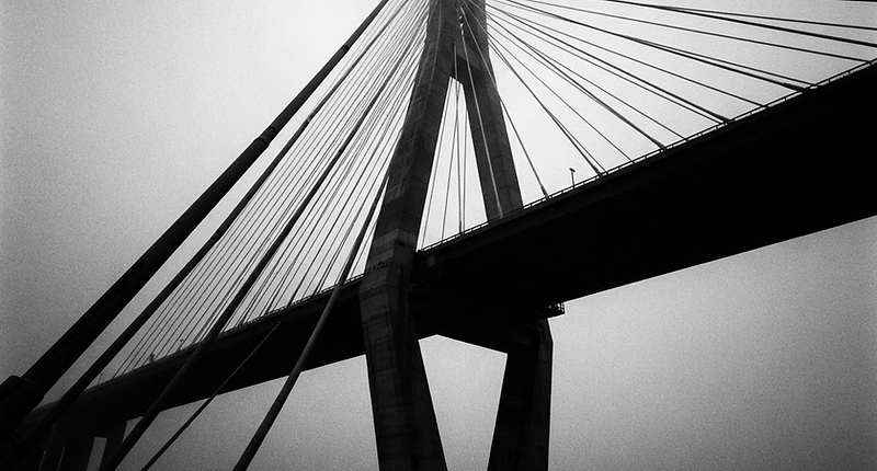 A cable-stayed bridge emerging from mist