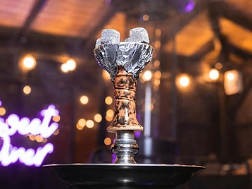 Lit hookah bowl in the Sweet Diner shisha garden