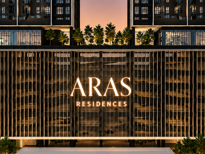 Aras Residences twin towers at dusk reflected in a still water feature
