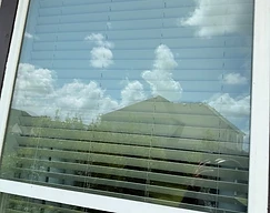 Dirty front door glass panel before cleaning