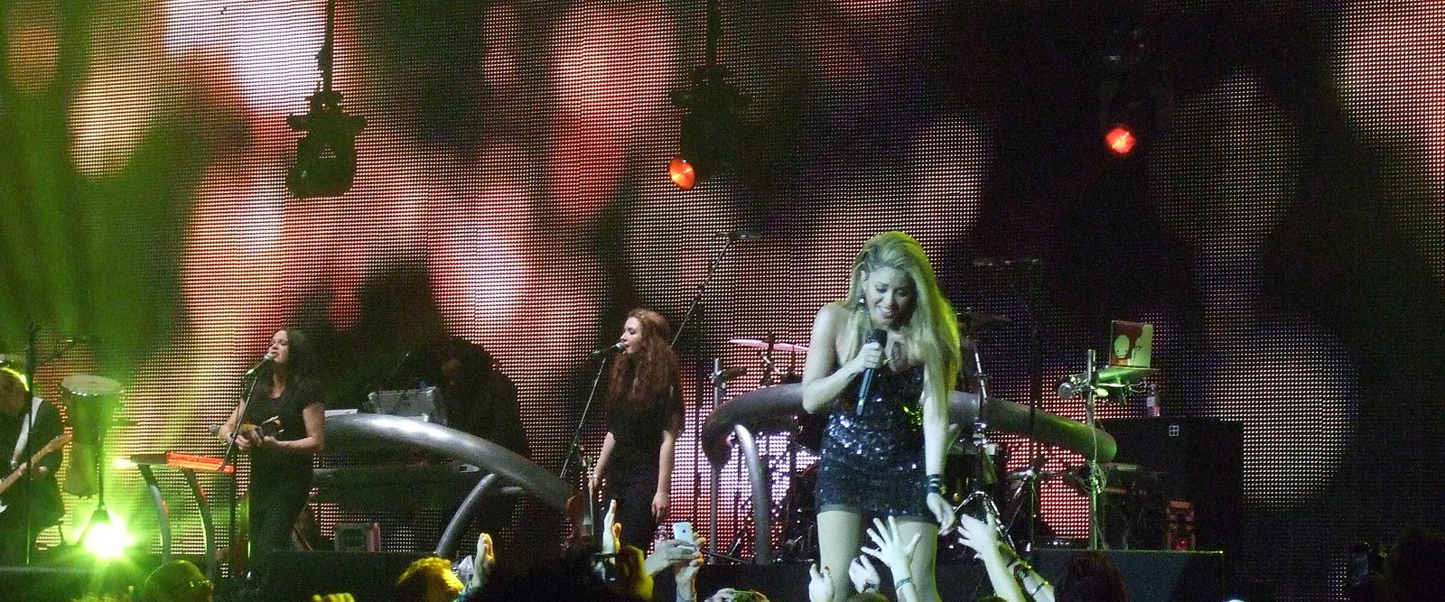 Shakira performing on stage in front of a crowd