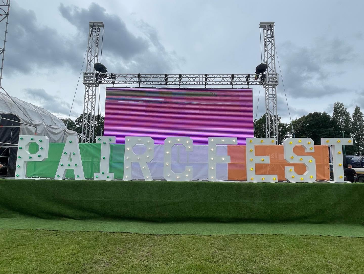 PaircFest marquee letters on stage with LED screen backdrop