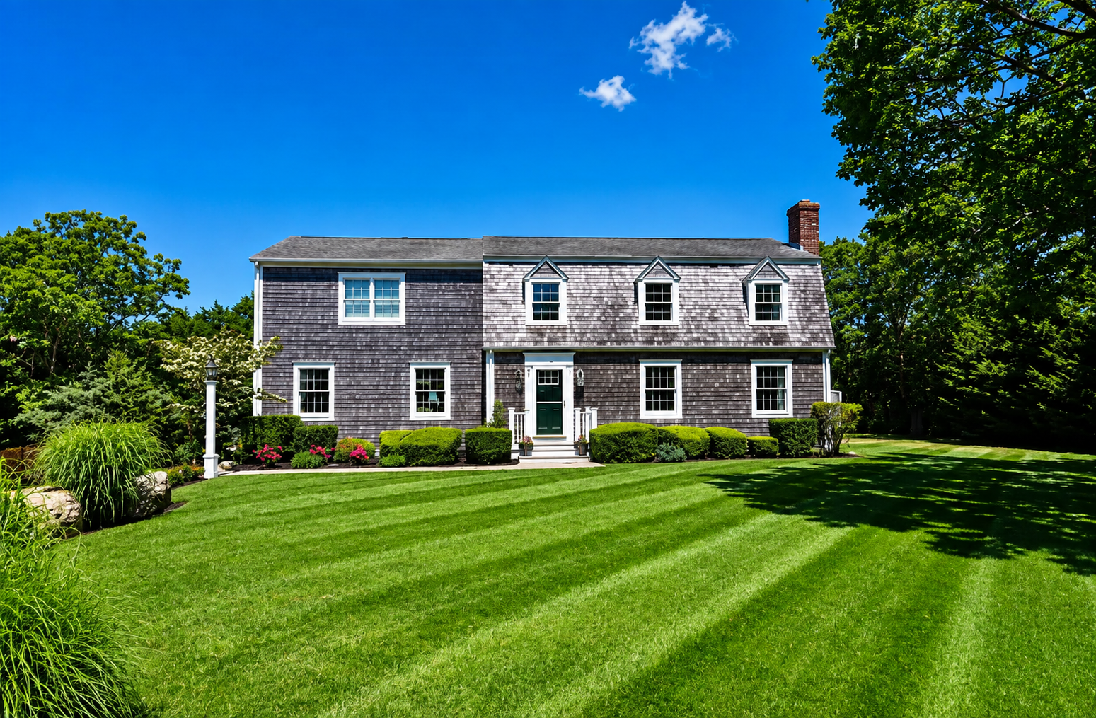 Aiden's Alcove — the grey-shingled Edgartown house on a green lawn under a blue sky