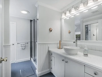Bathroom with vessel sink, glass shower, and slate tile floor