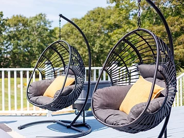 Close-up of the two hanging egg chairs on the deck