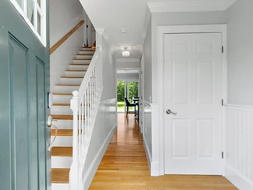 The hallway past the staircase toward the rear deck