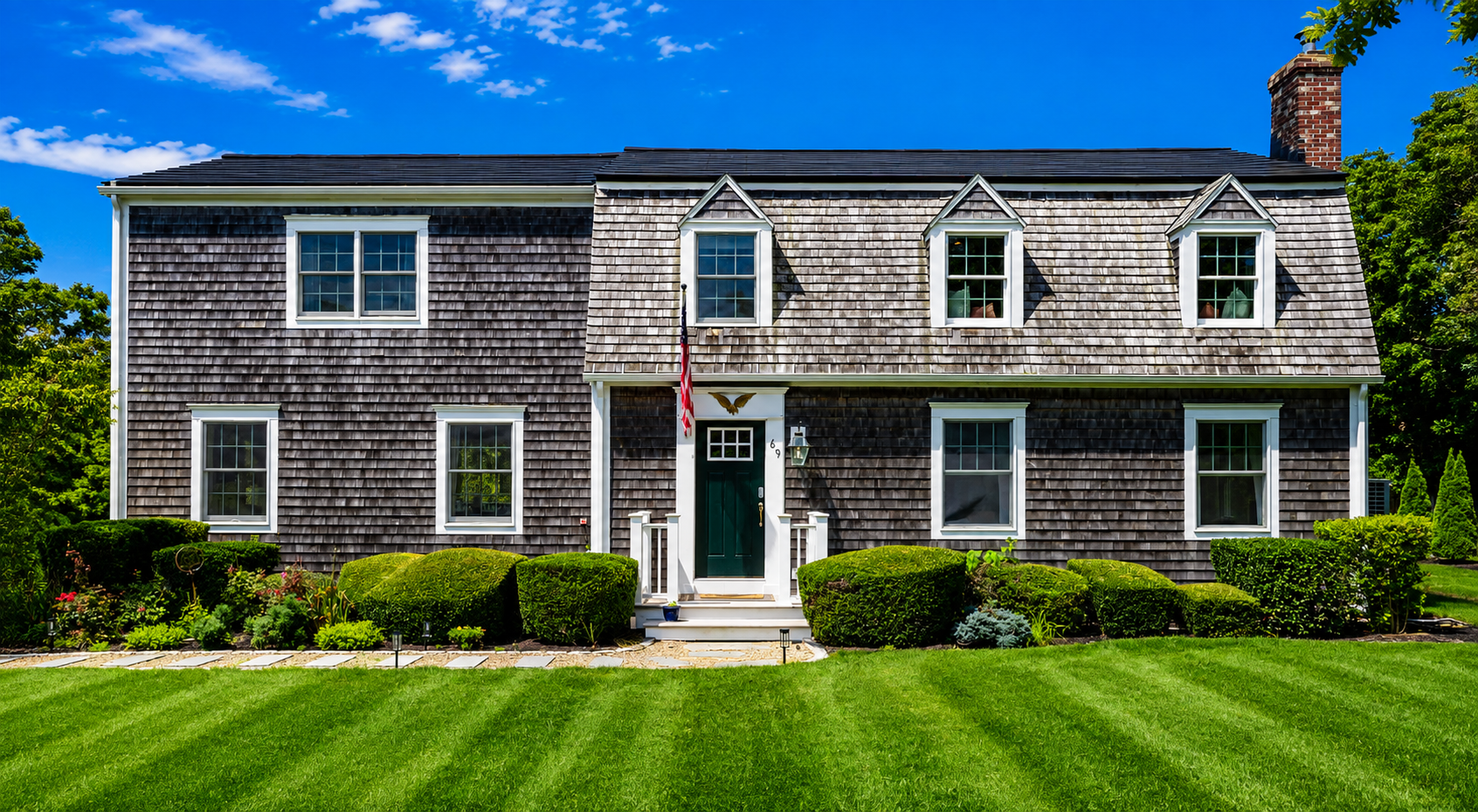 Aiden's Alcove — the grey-shingled Edgartown house on a green lawn under a blue sky