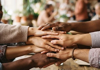 Diverse hands joined together in unity