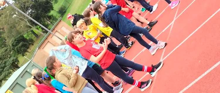 Students lined up across the athletics track ready for a sprint during the school sports carnival