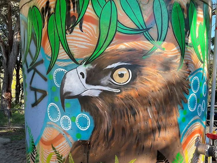 Indigenous mural at Warrandyte Primary School featuring a wedge-tailed eagle and native flora in dot-painting style