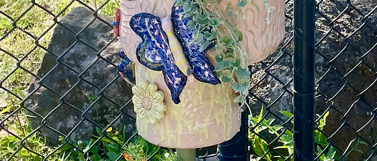 Ceramic butterfly garden totem sculpture made by students