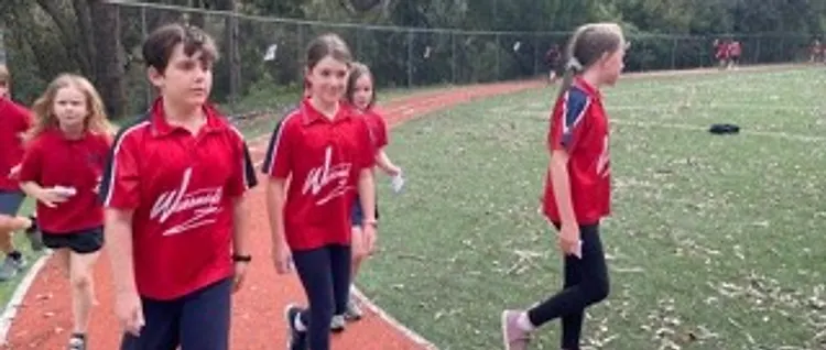 WPS students walking along the athletics track in school sport polos