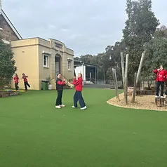 Students playing on the school turf and boulders