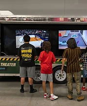 Kids gaming at the outside screens