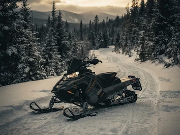 Snowmobile parked on a snowy trail