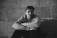Black-and-white portrait of Max White with his arms folded