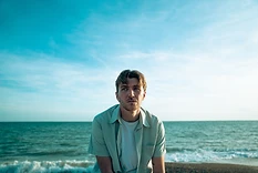 Max White on the beach beneath an open sky