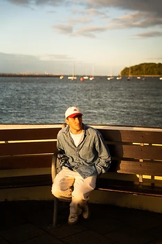 Max White seated by the harbour in evening sunlight