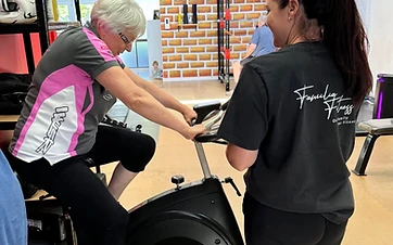 A senior member training with a Familia Fitness coach