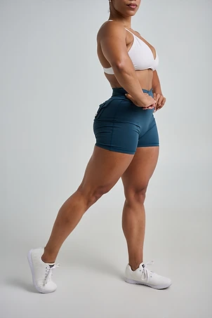 LaToya Loren, nurse practitioner and wellness bodybuilder, side profile showing a built lower body