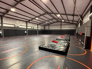 Interior of the Dead Shot wrestling room with Fuji mats and crash pads